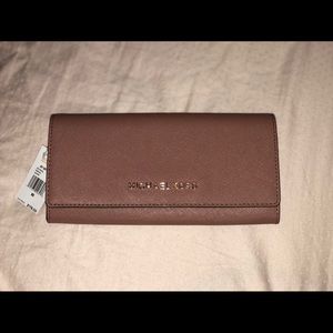 Never been used MK dusty mauve wallet.